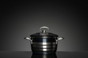 New cookware on black background, front view
