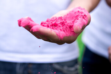 bright pink powder for holi festival of colors in hand closeup - Powered by Adobe