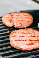 Hamburgers grilled on cast iron barbecue. High quality photo