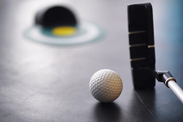 Sport and healthy lifestyle. Mini golf. White golf ball and set for minigolf on the table. Sports background with golf concept.