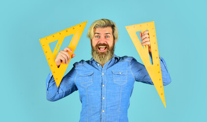 I love my job. mature bearded man hold triangle ruler. study at home. education. school teacher use...