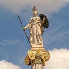 Fototapeta na wymiar Athena the goddess of knowledge and wisdom marble statue on Ionic column and partly cloudy sky