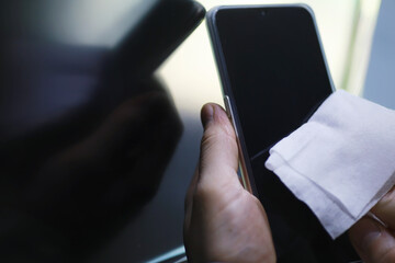 House cleaning concept. Wipe dust off surfaces. Disinfectant treatment of door handles TV electrical. Sanitary treatment at home in quarantine.