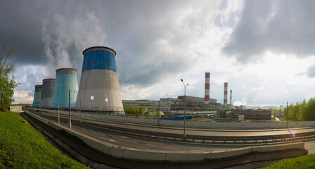 Obraz premium Cooling towers of a thermal power plant on a sunny summer day.