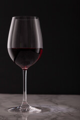 glass of red wine on marble table