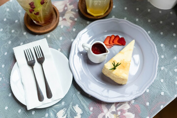 strawberry crepes cake with strawberry sauce on the table.