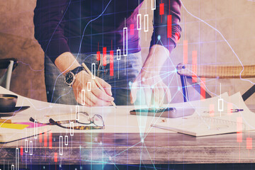 Multi exposure of man standing and planing investment with stock market forex chart.