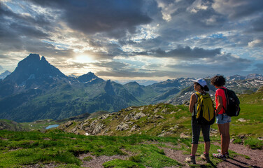 Fototapeta na wymiar two hiker women in path of Pic du Midi Ossau in french Pyrenees mountains