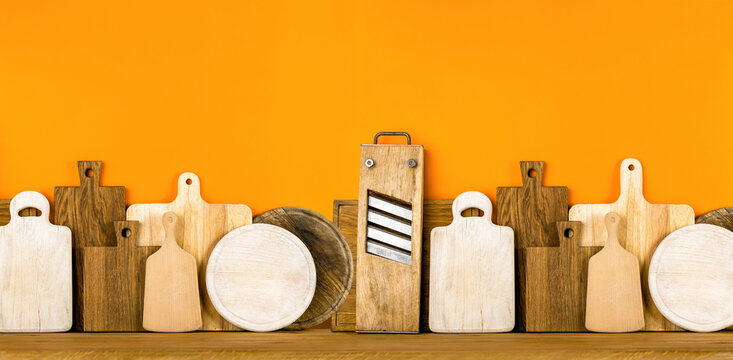 Kitchen utensils concept, cutting boards standing in a row front view