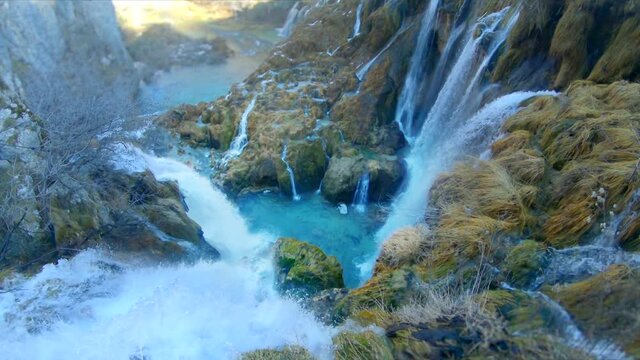 Incredible slow motion shot looking down through waterfalls tumbling down into the valey below, at Plitvice Natinal Park, Croatia