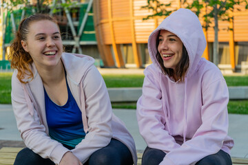 girls chatting and resting after training session. fitness, healthy lifestyle concept