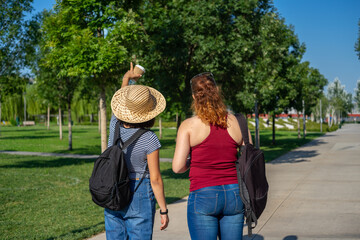 two young female tourists walking around the city for sightseeing
