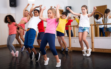 Boys and girls training in dance studio