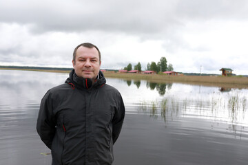 Man on background of Lake Seliger