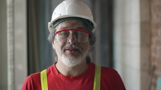 Mature foreman builder having video chat with contractor