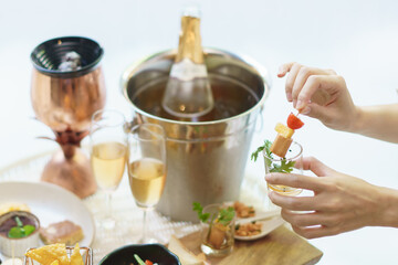 Woman hand holds different snacks and appetizers food at a cocktail party.