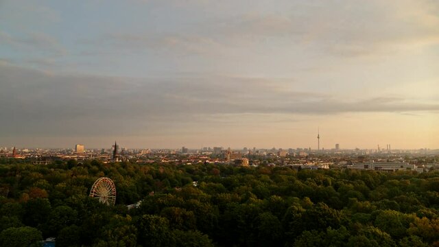 Treetops and cityscape at sunset, Berlin, Germany