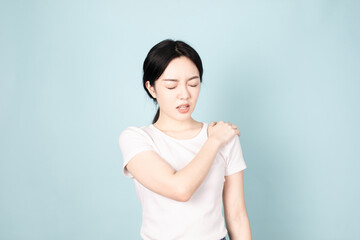 A young chinese woman in front of blue background