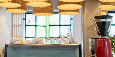 Obraz na płótnie Canvas Coffee shop bar counter, coffee machine, cafe restaurant decoration by wicker basket lamp.
