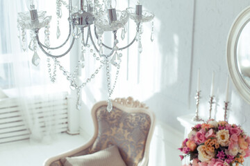 luxury clean bright white interior. a spacious room with sunlight and flowers in vases and royal chic furniture. 