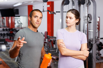 Fototapeta na wymiar Man and woman talking at gym