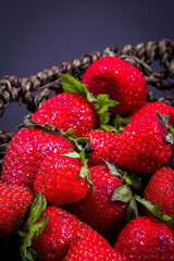 Cut kiwis and whole and sliced strawberries from close range.