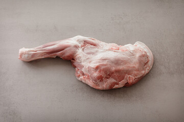 Raw leg of lamb with bone, fresh pink meat on neutral background