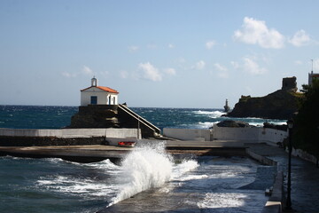 Waves at the small harbour in front of the Chapel of Panagia Thalassini at Andros, Greece 