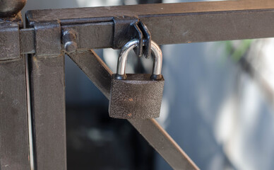 Padlock on the door. Metal mesh, wicket.
