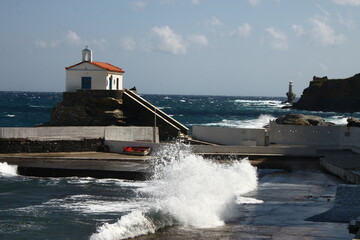 Waves at the small harbour in front of the Chapel of Panagia Thalassini at Andros, Greece 