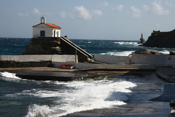 Waves at the small harbour in front of the Chapel of Panagia Thalassini at Andros, Greece 