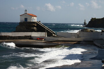Waves at the small harbour in front of the Chapel of Panagia Thalassini at Andros, Greece 