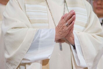priest folding his hands for prayer