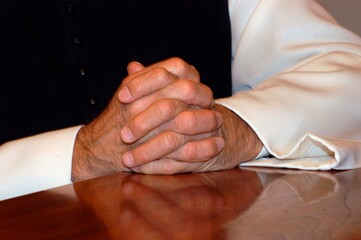 priest folding his hands for prayer