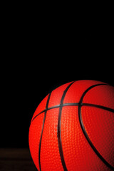 Fototapeta premium Basketball on a dark wooden floor, Dark background. Close up, Copy space.