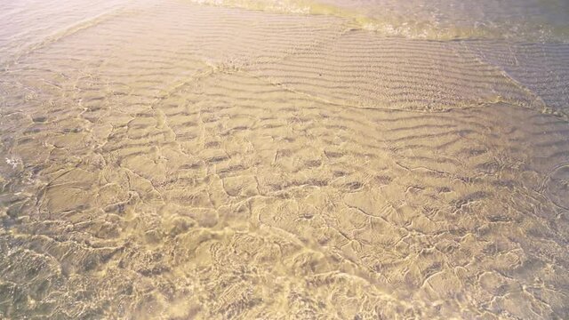 Sea Waves On The Sand At High Tide Create A Beautiful Changing Background Of Summer Mood. Vertical Camera Lift Above The Waves, Stranded By The Sea. Baltic Sea. Latvia