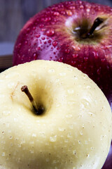 Close-up of some parts of the circle of a yellow and red apple in a basket.