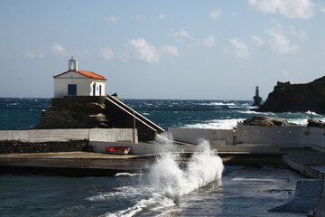 Waves at the small harbour in front of the Chapel of Panagia Thalassini at Andros, Greece 