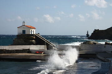 Waves at the small harbour in front of the Chapel of Panagia Thalassini at Andros, Greece 