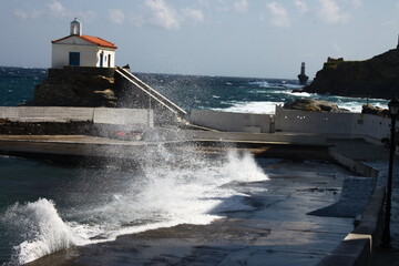 Waves at the small harbour in front of the Chapel of Panagia Thalassini at Andros, Greece 