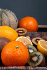 Sweet and sour fruits in one frame, such as kiwi, cantaloupe, pineapple, strawberry and orange.