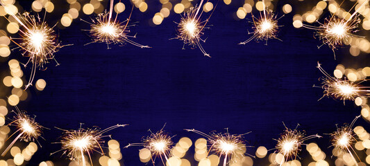 Frame of lights bokeh lights flares and sparkler isolated on dark blue texture - Holiday New Year's...