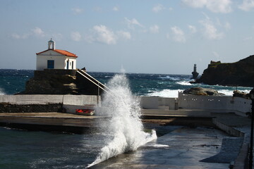 Waves at the small harbour in front of the Chapel of Panagia Thalassini at Andros, Greece 