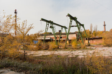 Fototapeta na wymiar Old rusty gantry bridge crane in abandoned industrial area