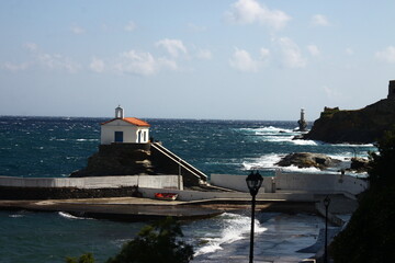 Waves at the small harbour in front of the Chapel of Panagia Thalassini at Andros, Greece 