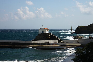 Waves at the small harbour in front of the Chapel of Panagia Thalassini at Andros, Greece 