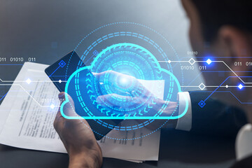 Businessman in office working with Smartphone, IT Cloud hologram to optimize the working process, typing phone. Double exposure.