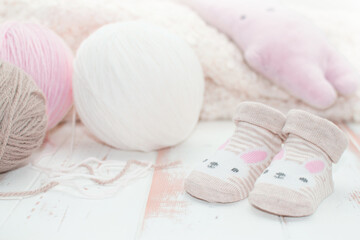 Close-up baby socks and wool ball