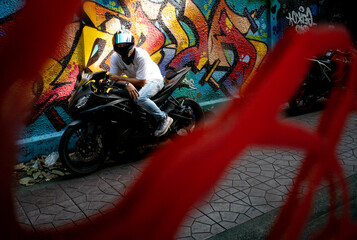 young boy sitting on a motorbike colorful background