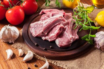 Raw fresh lamb chops on wooden cutting board